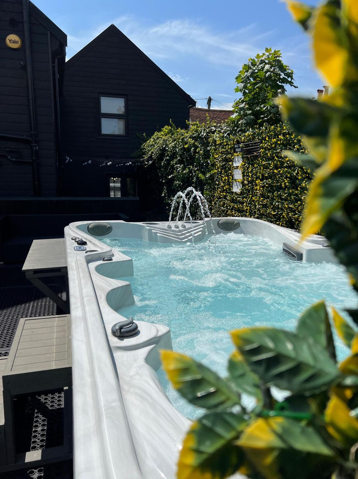 Double-size hot tub with fountains in the garden